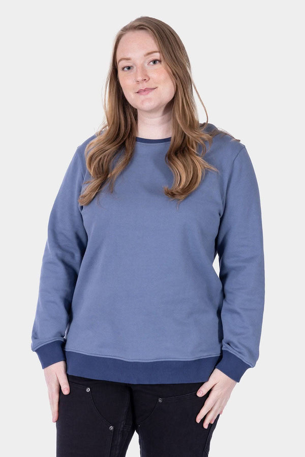 Slate Blue/Atlantic Blue GO TO™ Crew Sweatshirt by Dovetail Workwear worn by a woman, shown from the front, featuring a relaxed crewneck fit and ribbed cuffs