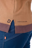 Detail view of the Dovetail Workwear GO TO™ Crew Sweatshirt in Saddle Brown showing the Dovetail graphic at hem and ribbed hem on a woman