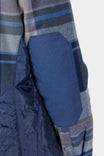 Detail view of the Durham Reversible Quilted Shirt Jac by Dovetail Workwear showing reinforced elbow patch and quilted insulation on the reversible side in Loden Green Plaid