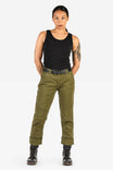 Dovetail Workwear GO TO™ Stretch Canvas Pant in Kelp Green shown on a woman wearing a black tank top, black lace-up boots, and a tool belt, standing against a white background