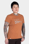 Woman wearing Dovetail Workwear GO TO "Get Dirty" Graphic Work Tee in rust orange with white front graphic against white background