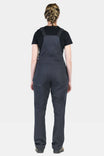Back view of a woman wearing Dovetail Workwear's Freshley Maternity Overalls in Navy Stretch Canvas, featuring reinforced knees and nested pockets
