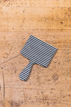 Indigo Stripe Denim Tool Patch (3" X 2") from Dovetail Workwear x NoSo DIY Repair Patches displayed on cork surface, showing indigo and white striped fabric design