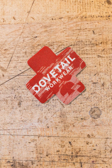 Dovetail Workwear x NoSo DIY Repair Patches displayed on a wooden surface, showing the peel-and-stick fabric patches for gear repair