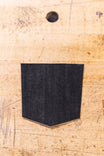 Black Denim Pocket Patch from Dovetail Workwear x NoSo DIY Repair Patches displayed on cork surface