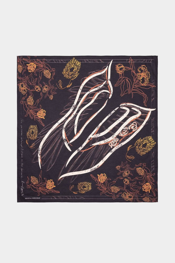 Rae Ripple x Dovetail Workwear Brave Wings Bandana in black displayed flat, featuring hand-drawn wing illustrations and floral designs in colors pulled from Rae Ripple's metal shop on a dark background