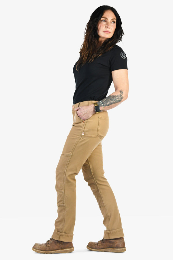 Back view of a woman wearing Dovetail Workwear GO TO™ Stretch Canvas Pant in Sawdust Brown, showcasing the tool loop, nested pockets, and straight leg fit