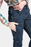 Close-up detail of Dovetail Workwear's Britt X Pant Power Hemp in Indigo, highlighting nested pockets and reinforced knee area on a woman wearing a plaid shirt