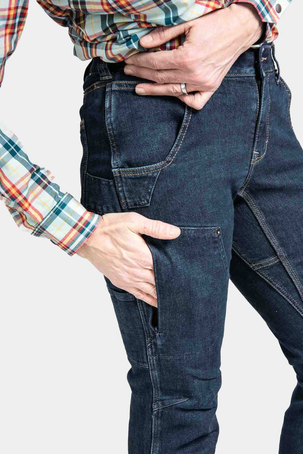 Close-up detail of Dovetail Workwear's Britt X Pant Power Hemp in Indigo, highlighting nested pockets and reinforced knee area on a woman wearing a plaid shirt