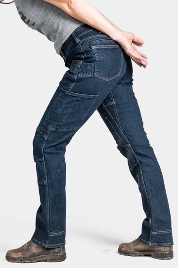 Back view of a woman wearing Dovetail Workwear's Britt X Pant Power Hemp in Indigo, showcasing the reinforced knees and straight leg fit with nested pockets