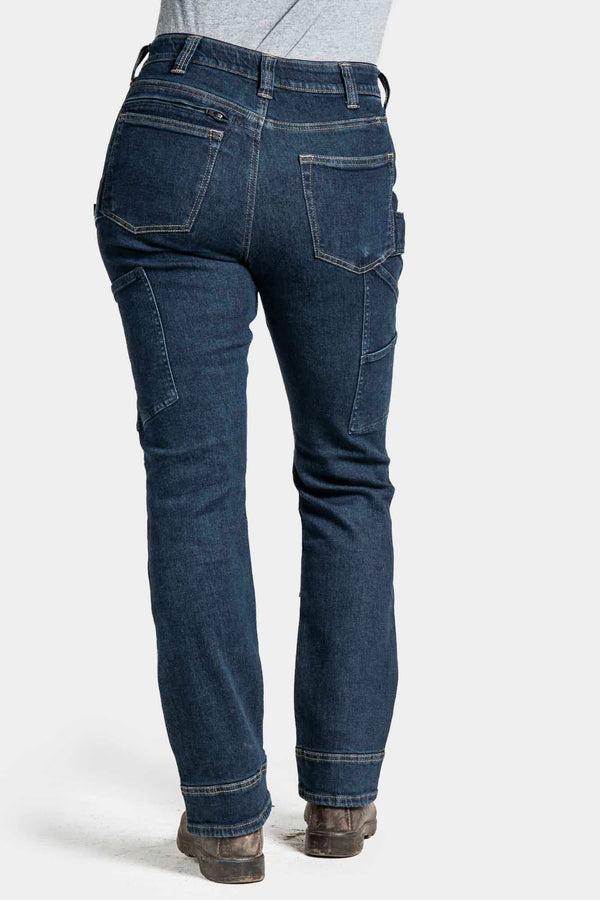 Back view of a woman wearing Dovetail Workwear's Britt X Pant Power Hemp in Indigo, showcasing reinforced knees, nested pockets, and straight-leg silhouette