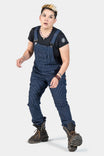 Freshley Overalls in Wabash Stripe by Dovetail Workwear shown on a woman wearing dark boots, featuring visible suspenders, nested pockets, and reinforced knees
