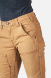 Detail view of the Maven X Pant in Saddle Brown Canvas by Dovetail Workwear, highlighting reinforced knees and nested pockets on a woman wearing a navy shirt