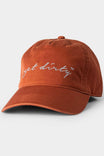 Dovetail Workwear Shop Cap in Vintage Paprika displayed against a light background, featuring white embroidered script branding and adjustable sizing