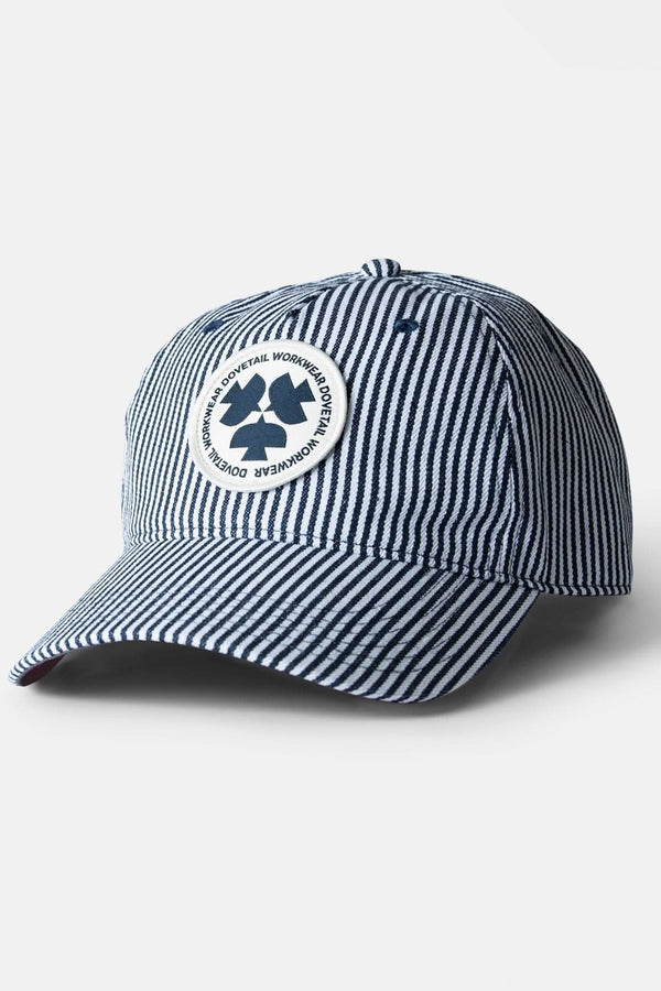 Indigo Stripe Shop Cap from Dovetail Workwear featuring vertical pinstripes, adjustable sizing, breathable mesh, and a circular logo patch on the crown