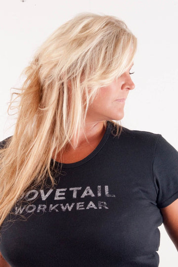 Side view of a woman wearing the Dovetail Logo Tee, showcasing the classic Dovetail logo and flattering fit