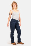 Anna Taskpant in Uniform Navy Canvas by Dovetail Workwear, shown on a woman in a gray tank top, featuring Hip Slot™ Tool loop, Nested Pockets, reinforced knees, and a straight leg silhouette