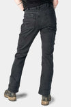 Back view of a woman wearing Dovetail Workwear Britt Utility Pant in Black Stretch Thermal Denim, showing cargo-style pockets, reinforced knees, and rolled cuffs with work boots