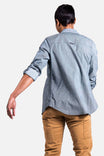 Back view of a woman wearing the Givens Work Shirt in Indigo Stripe by Dovetail Workwear, paired with tan cargo pants, showcasing the chest pocket and rolled sleeves