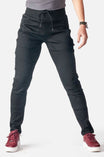 Christa DIY Pant in Black Performance Modal by Dovetail Workwear with reinforced knees and multiple pockets, worn by a woman with burgundy sneakers