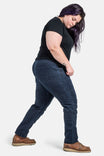 Back view of a woman wearing Dovetail Workwear's Christa DIY Pant in Sulfur Navy Stretch Twill, showcasing the reinforced knees and nested pockets