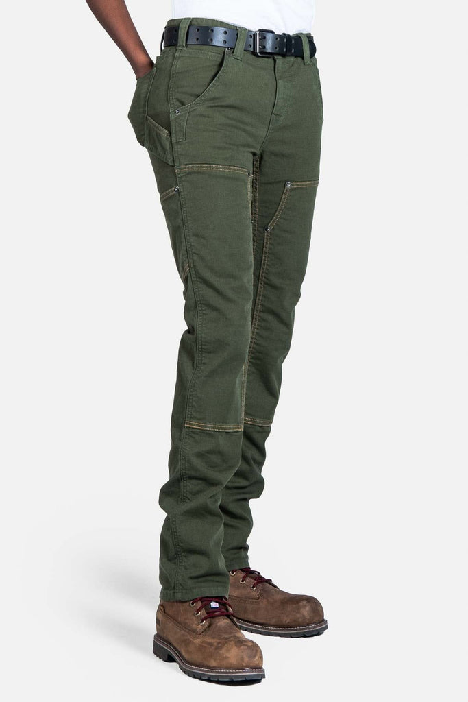 Side view of a woman wearing Dovetail Workwear's Maven X Pant in Moss Green Canvas, showcasing the slim leg fit, cargo pockets, and Reinforced Knees design