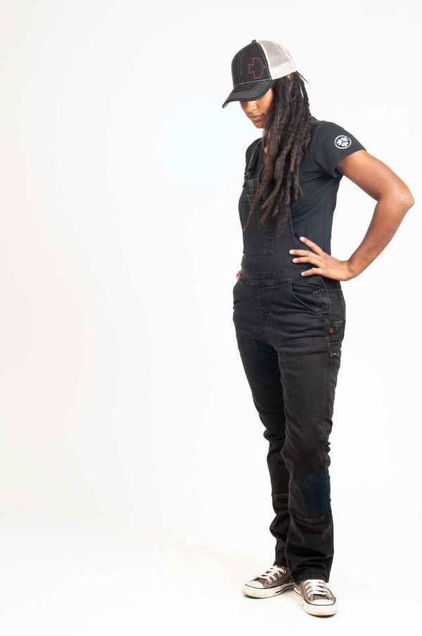Dovetail Embroidered Shop Cap in Blue/Black worn by a woman with dreadlocks, styled with a black t-shirt and dark jeans, shown in a full-length standing pose against a white background