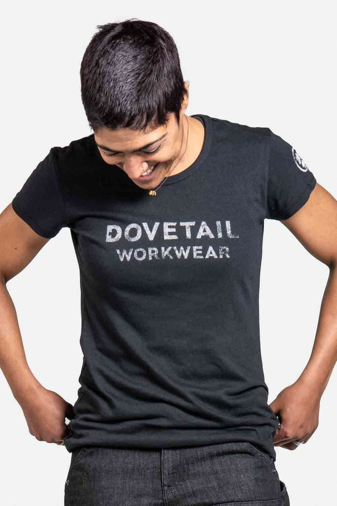 Dovetail Logo Tee worn by a woman looking down, featuring the classic Dovetail Workwear logo across the chest