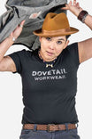 Dovetail Logo Tee worn by a woman styled with a tan cowboy hat, layered gray jacket, and brown leather belt