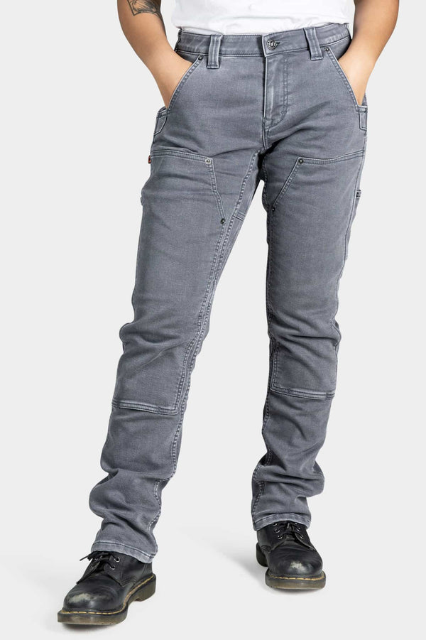 Maven X Slim Pant in Grey Stretch Thermal Denim by Dovetail Workwear shown on a woman, featuring reinforced knees, tool loops, and a slim-fit silhouette