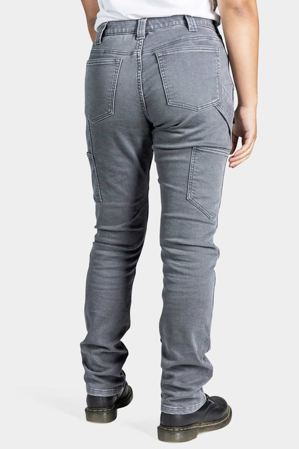 Back view of a woman wearing the Maven X Slim Pant in Grey Stretch Thermal Denim by Dovetail Workwear, showcasing reinforced knees and classic five-pocket styling