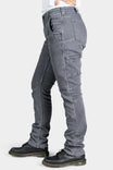 Side view of a woman wearing the Maven X Slim Pant in Grey Stretch Thermal Denim by Dovetail Workwear, featuring nested pockets and reinforced knees
