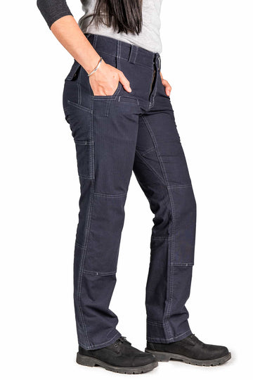 Side view of a woman wearing Dovetail Workwear's Day Construct Pant in Lightweight Dark Navy Ripstop, showcasing the relaxed fit, phone pocket, and reinforced knee design