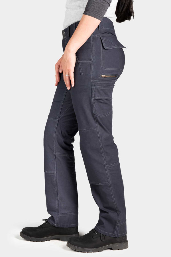 Side view of a woman wearing Dovetail Workwear's Day Construct Pant in Lightweight Dark Navy Ripstop, highlighting the relaxed fit, phone pocket, and reinforced knee design
