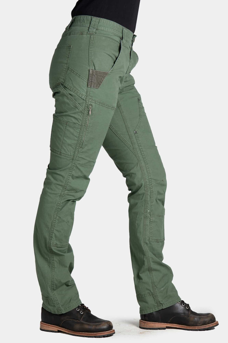 Side view of a woman wearing Dovetail Workwear's Britt X Ultralight Work Pant in Lichen Green Ripstop, showing cargo-style pockets, reinforced knees, and straight leg fit
