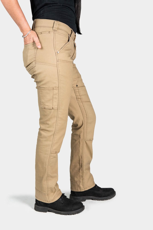 Side view of a woman wearing Dovetail Workwear's Anna Taskpant in Khaki Canvas, showcasing Hip Slot™ Tool loop, nested pockets, reinforced knees, and straight leg silhouette