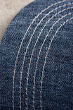 Close-up detail of the Dovetail Embroidered Shop Cap showing blue denim fabric with contrast cream-colored mesh in parallel lines
