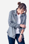 Dovetail Workwear's Givens Work Shirt in Indigo Stripe worn by a woman layered over a white tee, featuring visible chest pocket and cuff tabs
