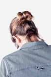Back view of a woman wearing the Givens Work Shirt in Indigo Stripe by Dovetail Workwear, showcasing the chest pocket and striped fabric detail