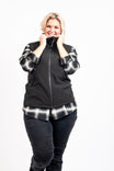 Dovetail Workwear M'fon Work Vest in black, worn by a woman with hands near the collar, paired with dark jeans